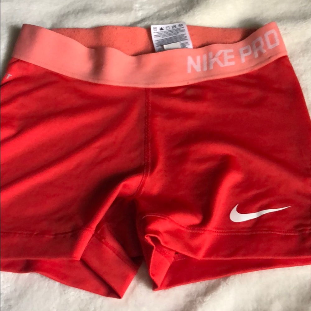 Red and Coral Nike Pros